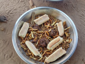 The finished product! Sheep and goat meat with macaroni, fries, chopped onions, and dense village bread. Tabaski is a marathon, not a sprint. It's  custom to eat at the neighbors and have bowls of food sent over, so it's all about pacing yourself. Come and eat!