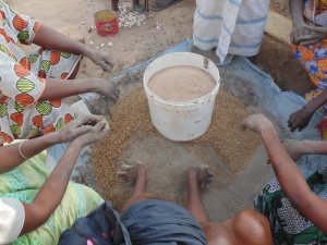A bucket of sand, a bucket of millet chaff, and a bucket of clay and many enthusiastic hands are essential ingredients for a clay stove. 